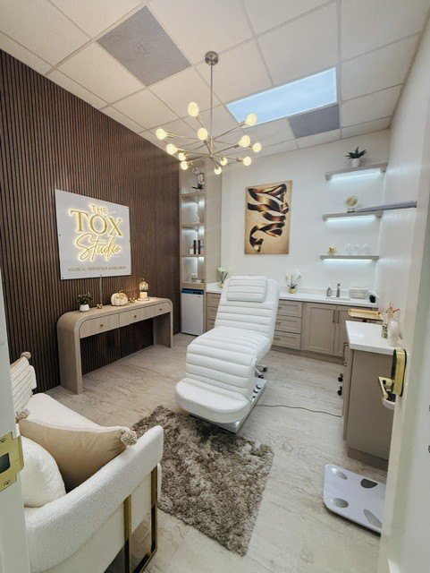 Treatment room at The Tox Studio with the studio's lit sign